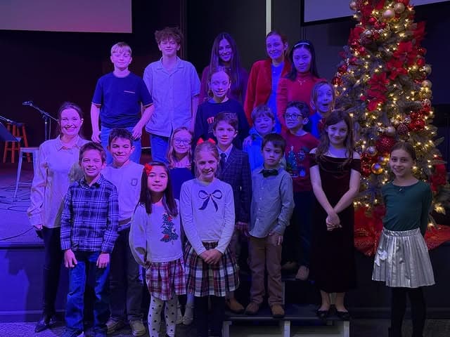 Students beside the Christmas tree at the winter recital